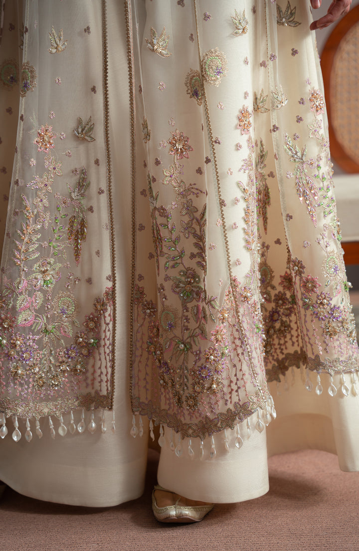 Close-up of a embroidered traditional outfit with floral patterns and beads.